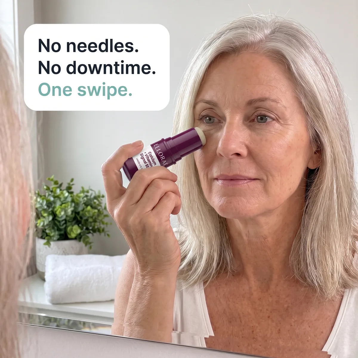 Woman in her late 50s gliding the balm stick under her eye: no needles, no downtime, one swipe