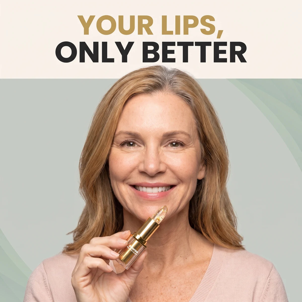 Woman in her 50s smiling with sheer rosy lips, holding the Ellorae lipstick